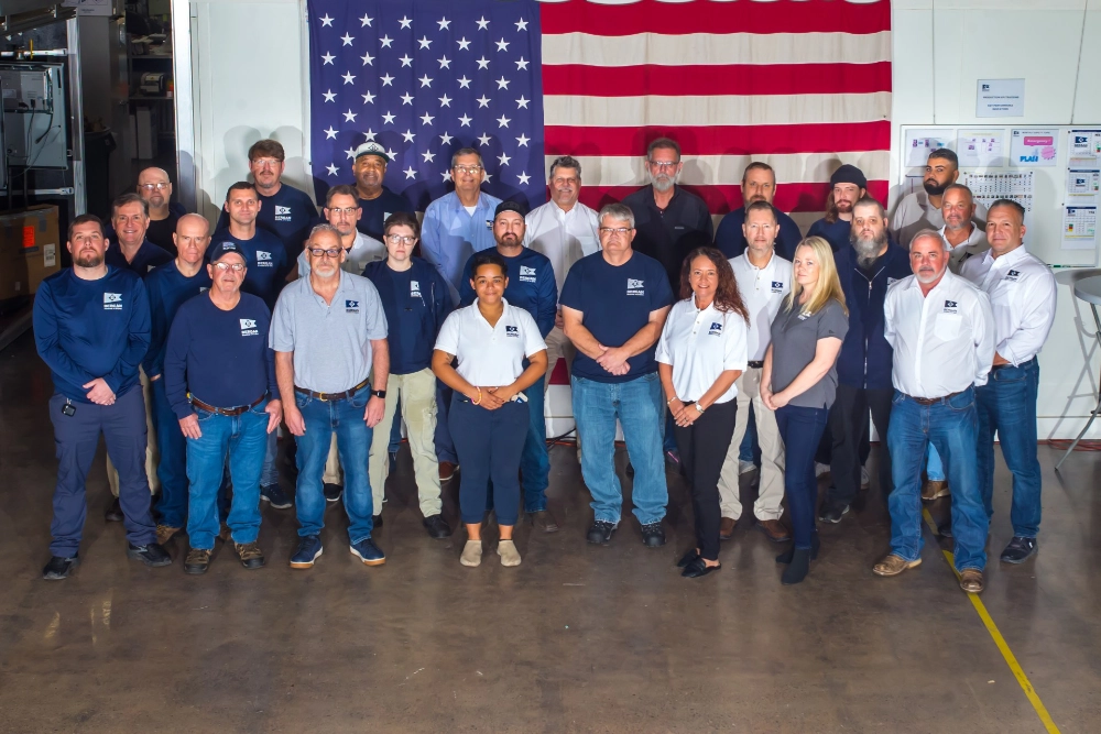 A photo of the Bergan Marine Systems Team in front of an American flag.