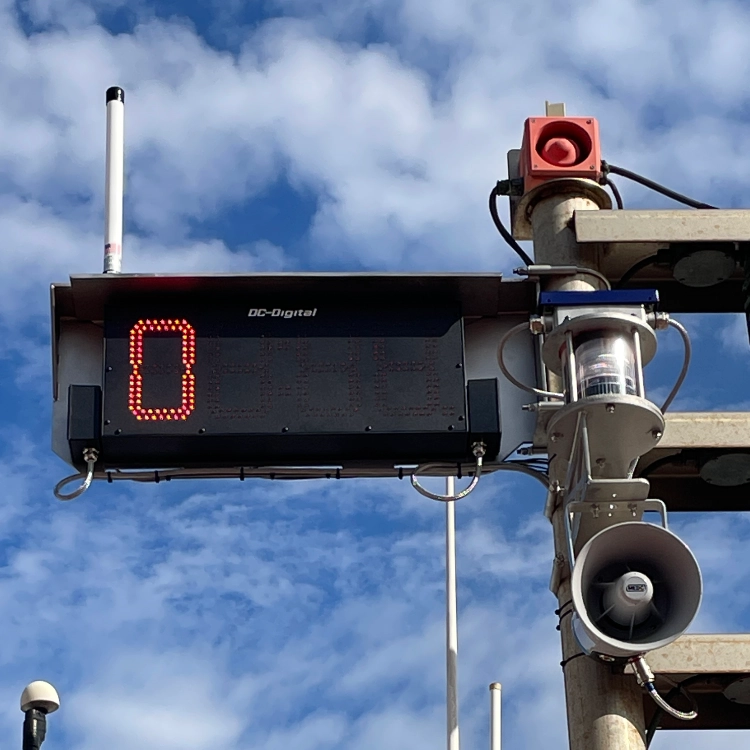 A photo of a timer attached to an alarm tree.