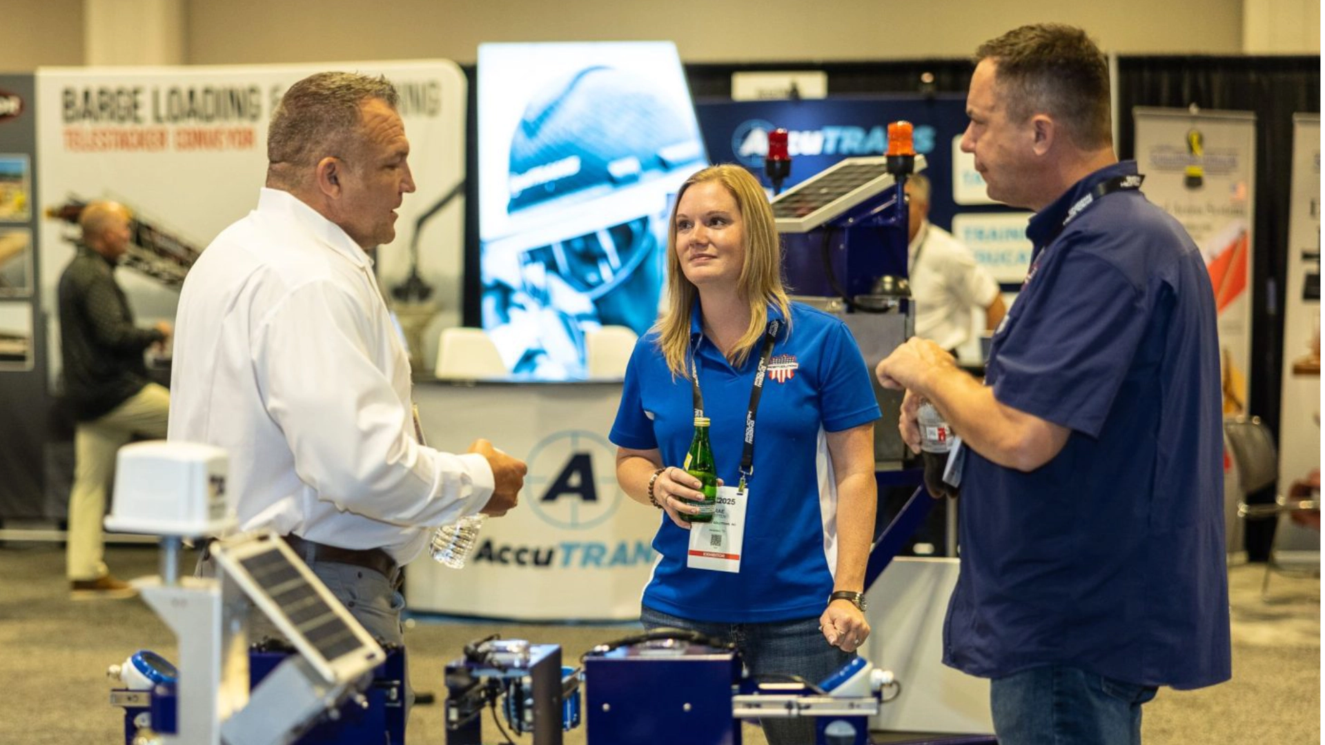 A photo of Bergan employee discussing with others at a trade show.
